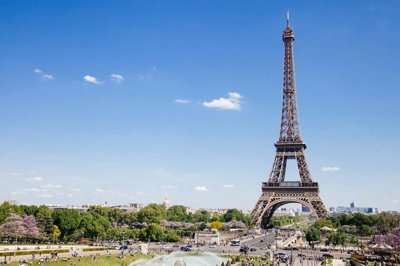 The Eiffel Tower across the Seine in Paris, with the stone embankment in the foreground.