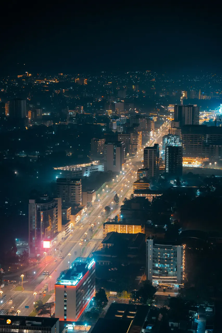 Addis Ababa at night from above, with a lit avenue running through the city.