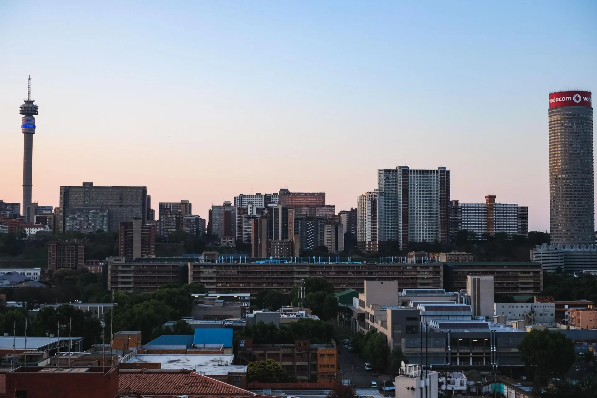Downtown Johannesburg at dusk, with the Hillbrow Tower and Ponte City on the skyline.